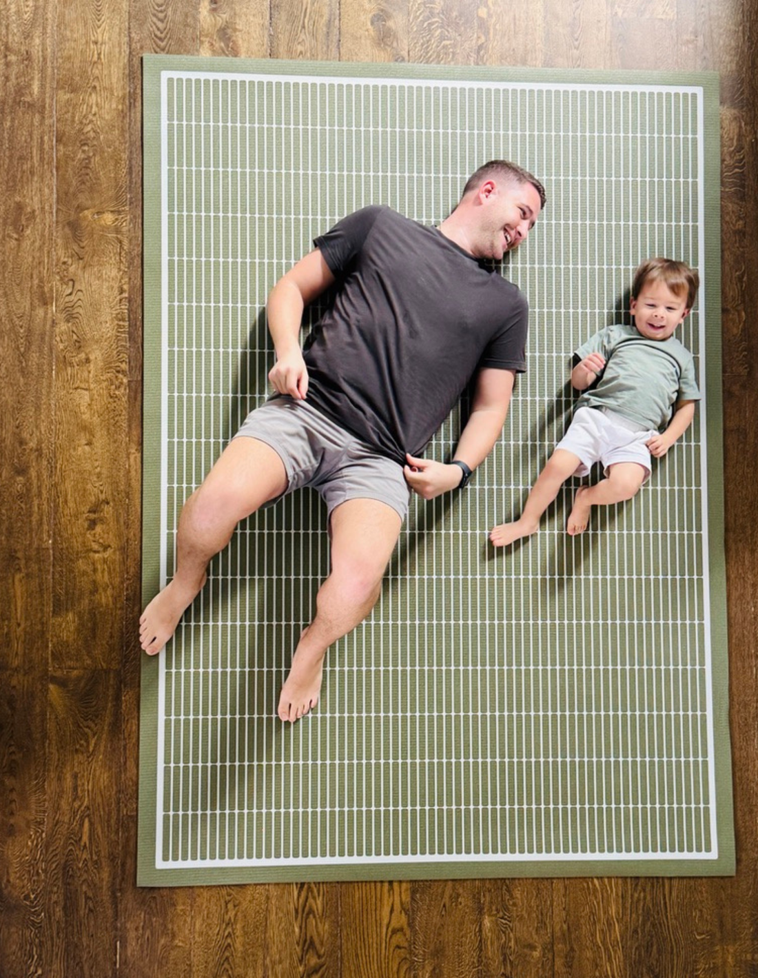 Arlo Olive Swankymat, a non-toxic high-density foam exercise mat in an olive-green geometric grid, styled in a modern living room as a rug alternative