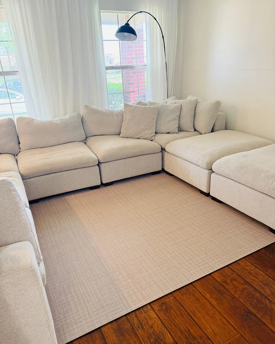Sloane Dust Swankymat styled like a rug in a living room, a non-toxic high-density foam exercise mat that doubles as a decorative rug alternative