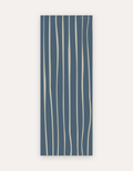Wavy Cove Studio Mat, a rollable non-toxic high-density foam studio mat with free-flowing cream wavy lines over deep slate blue, shown flat for yoga, pilates and HIIT
