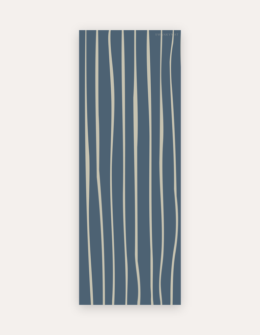 Wavy Cove Studio Mat, a rollable non-toxic high-density foam studio mat with free-flowing cream wavy lines over deep slate blue, shown flat for yoga, pilates and HIIT