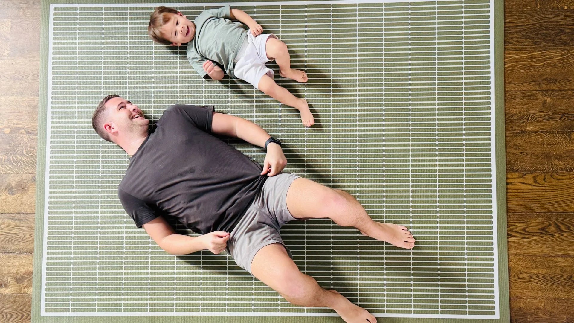 Man and child on Swankymat non toxic rug alternative mat for yoga and play.