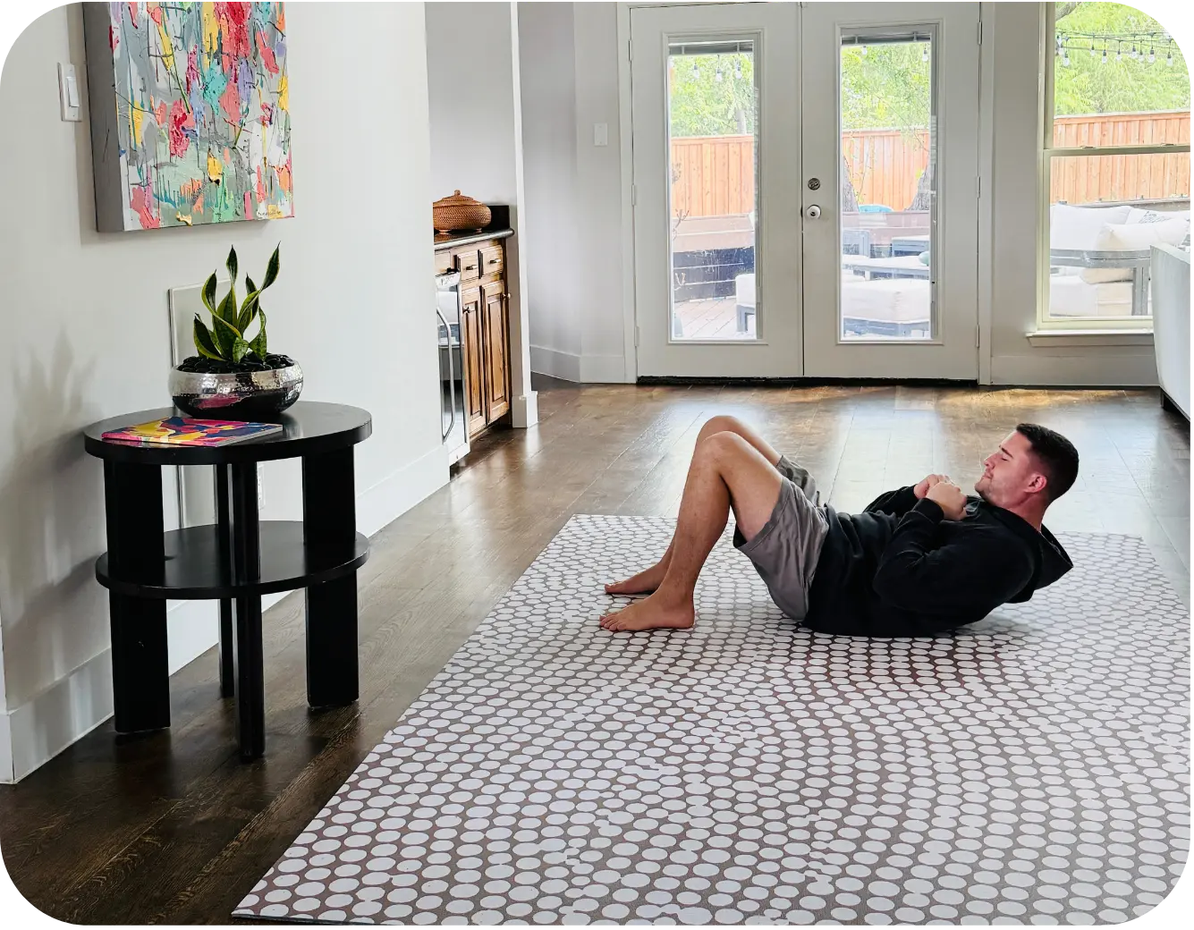 Man exercising on large mat in home