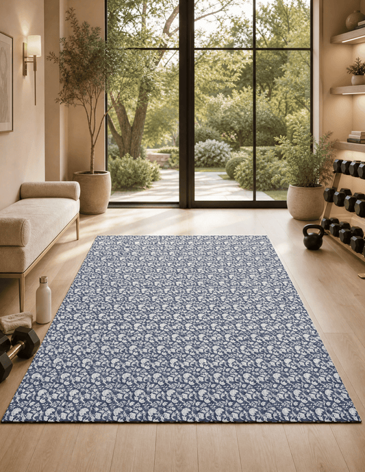 Flora Indigo extra-large mat in indigo floral laid out in a soft, feminine home gym, showing the 6x9 ft non-toxic foam as workout and play space