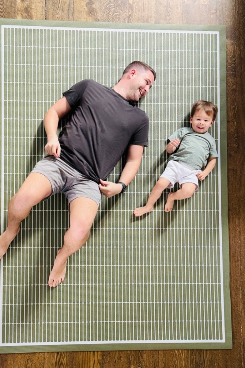 Dad with son playing on non toxic green yoga mat and play mat