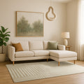 Neutral striped Swankymat exercise mat and play mat in modern living room with beige sofa, wood floor, and soft lighting.