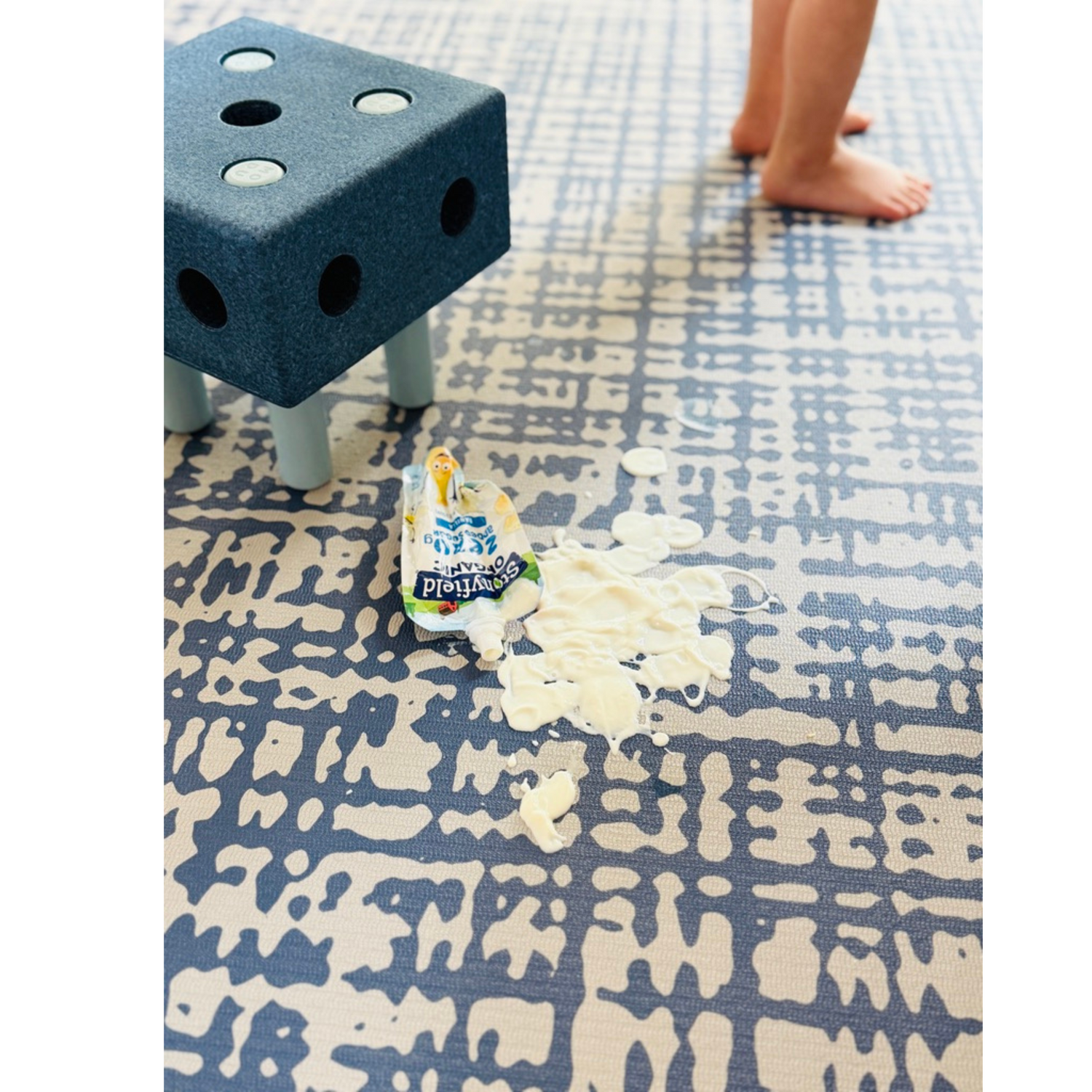 Spilled yogurt on Sloane Navy exercise mat and play mat showing easy clean surface