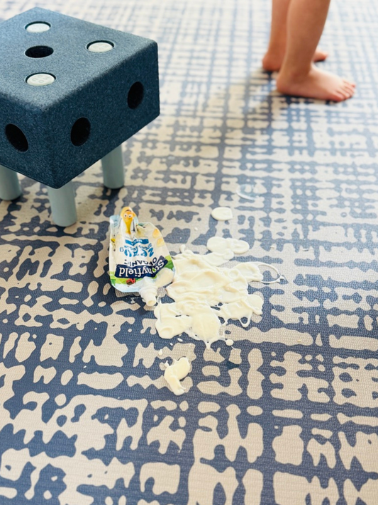 Spilled yogurt on Sloane Navy exercise mat and play mat showing easy clean surface