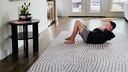 Man doing exercise on non toxic Swankymat decorative mat for yoga, fitness, and play