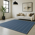Swankymat navy pattern foam exercise mat and play mat styled in modern living room with sofa and artwork.