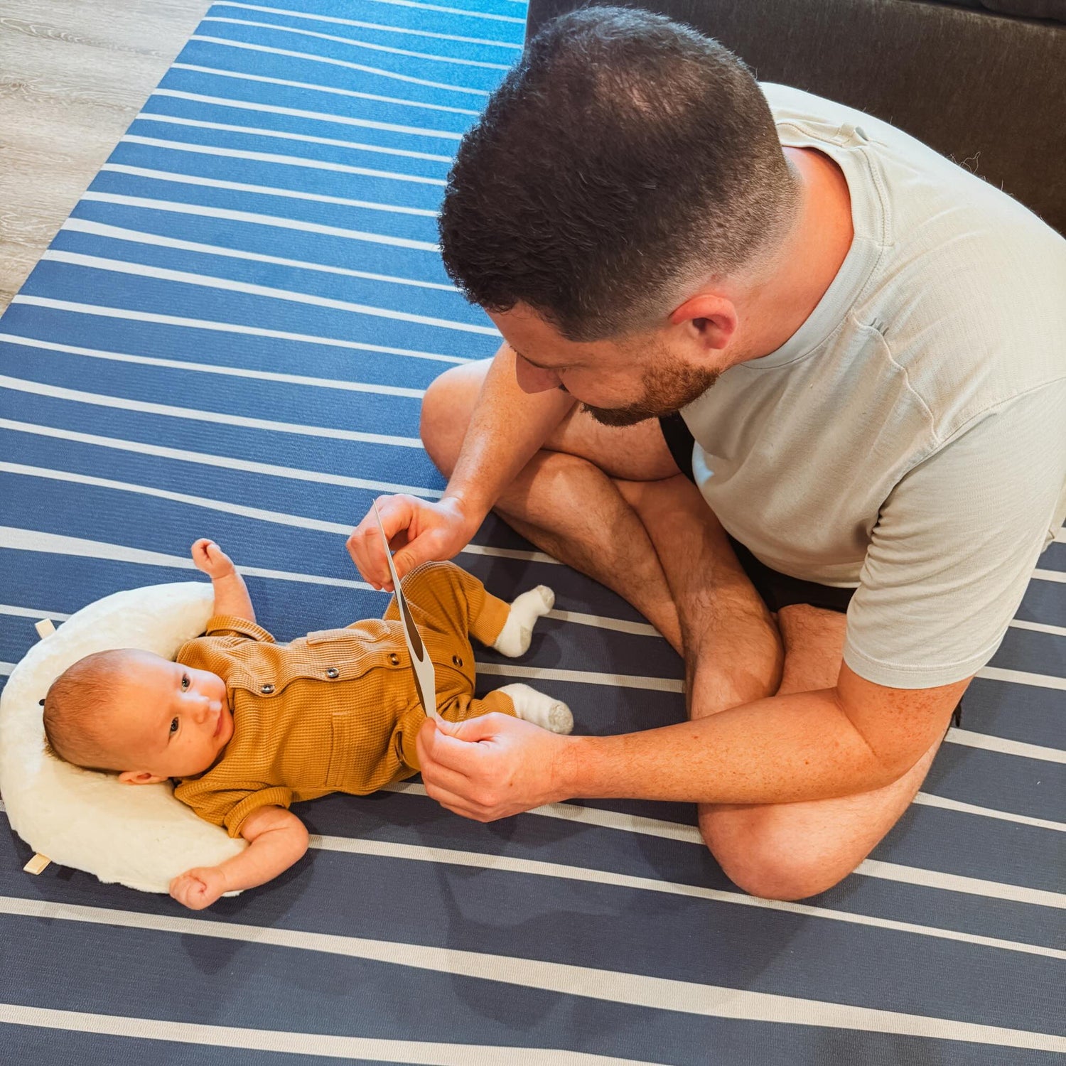 Father playing with son on blue pattern Swankymat rug alternative for yoga, exercise and play.