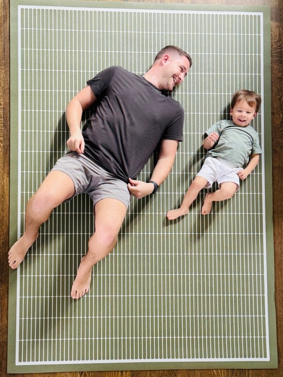Father and toddler relaxing on Arlo Olive extra large yoga mat and baby play mat in modern living room
