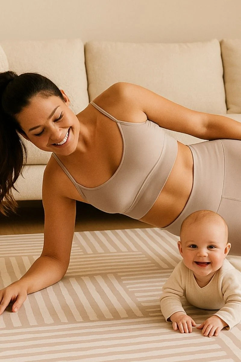 Swankymat non-toxic foam play mat and exercise mat in modern neutral stripe design, with mom doing side plank and baby lying on mat in living room.