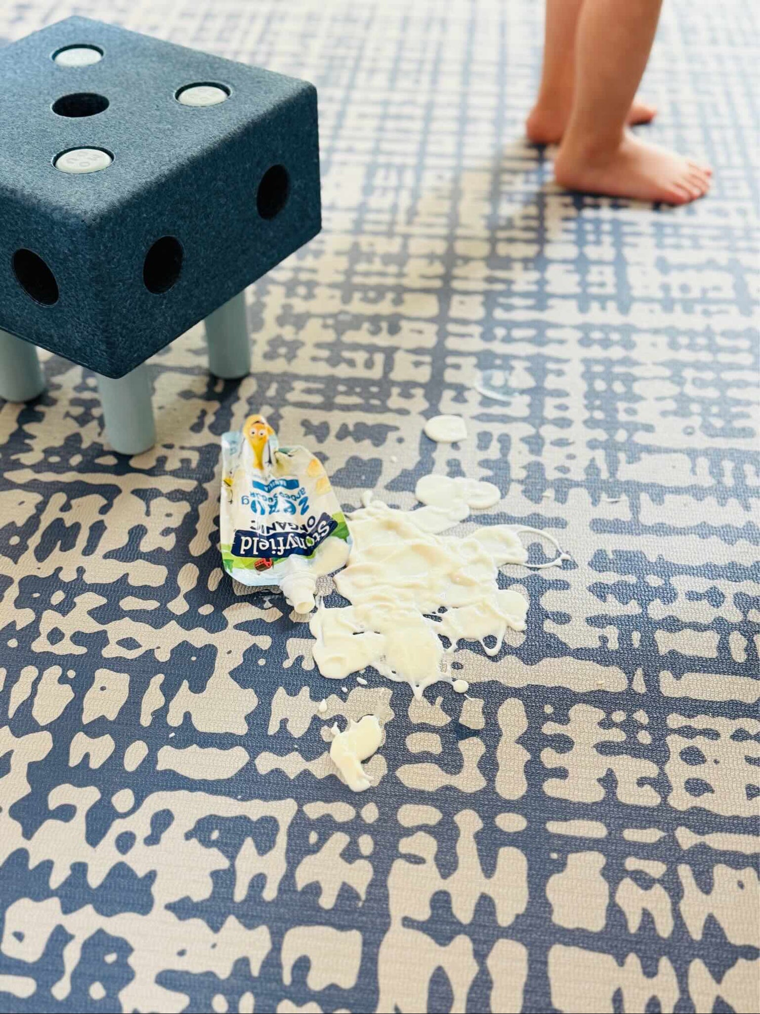 Swankymat Sloane Navy non-toxic eco-friendly exercise mat and play mat with yogurt spill showing easy-to-clean wipeable surface